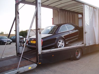 Bentley being transported by road